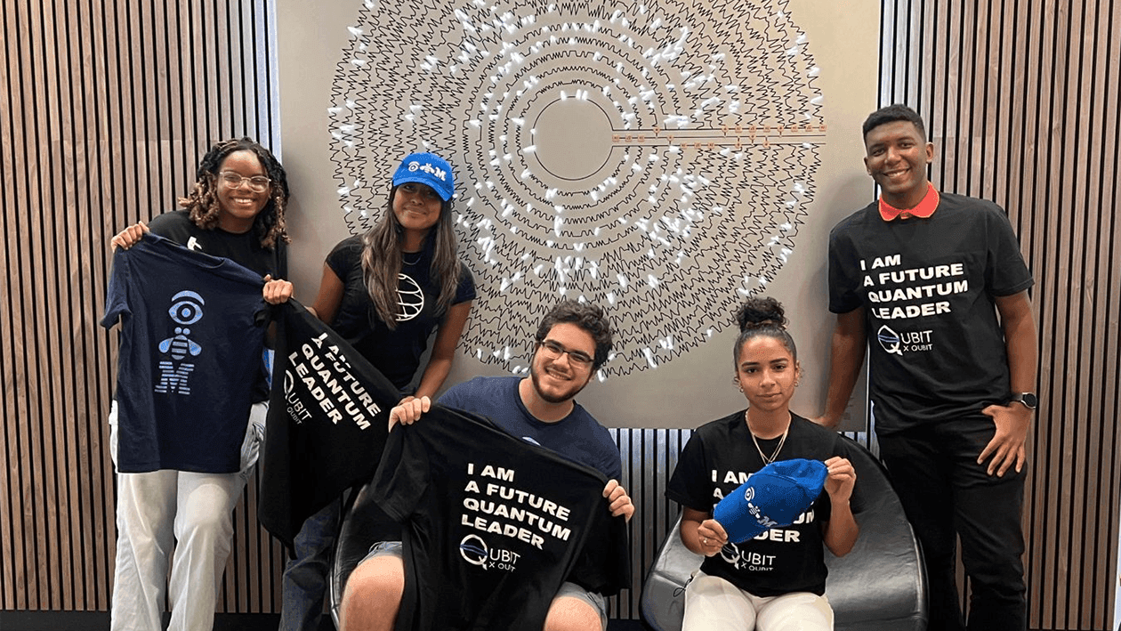 Qubit by Qubit Early Quantum Career Immersion interns in front of the Teleportation Disk quantum art installation in New York City.