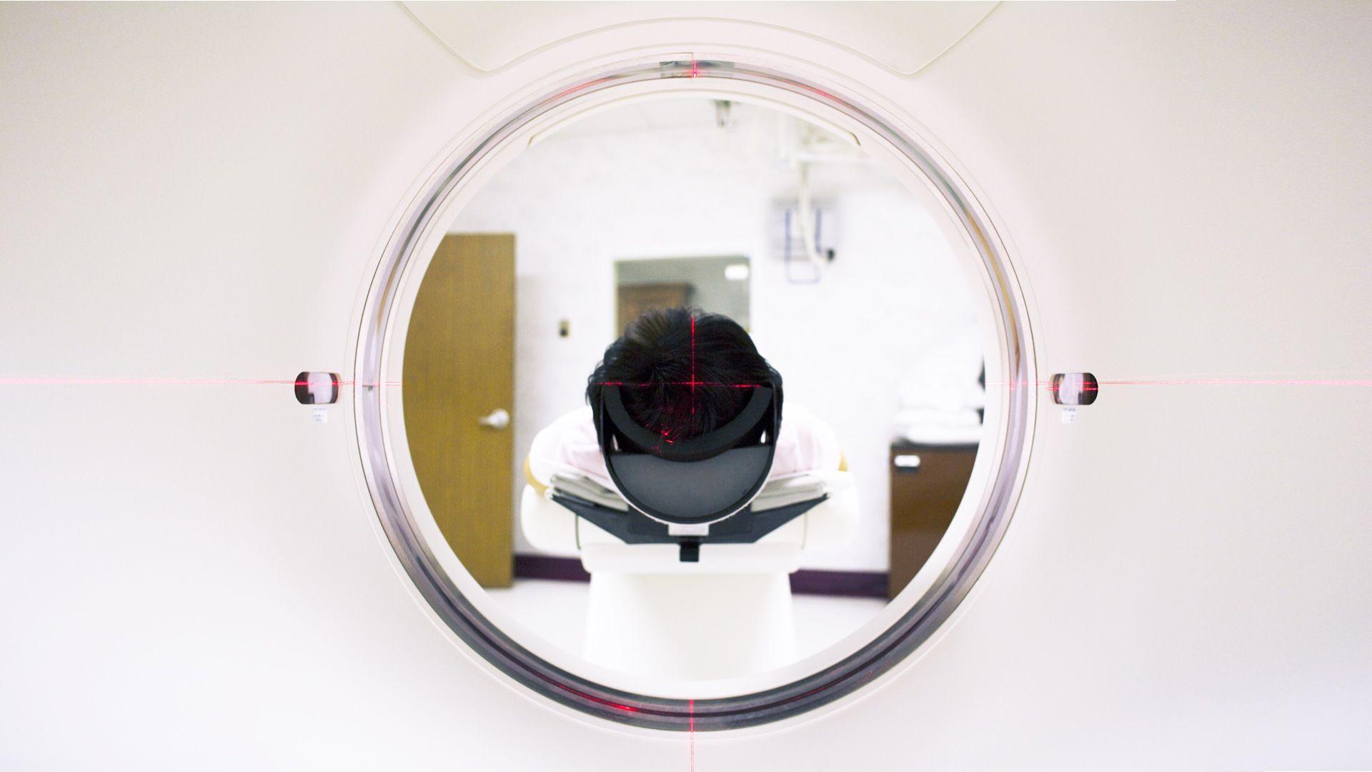 photograph of an person entering a medical scanner